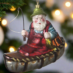 blown glass santa in canoe christmas ornament